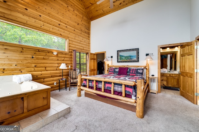 carpeted bedroom with high vaulted ceiling and connected bathroom