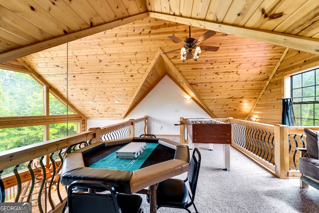 rec room featuring ceiling fan, wood ceiling, lofted ceiling with beams, and carpet flooring