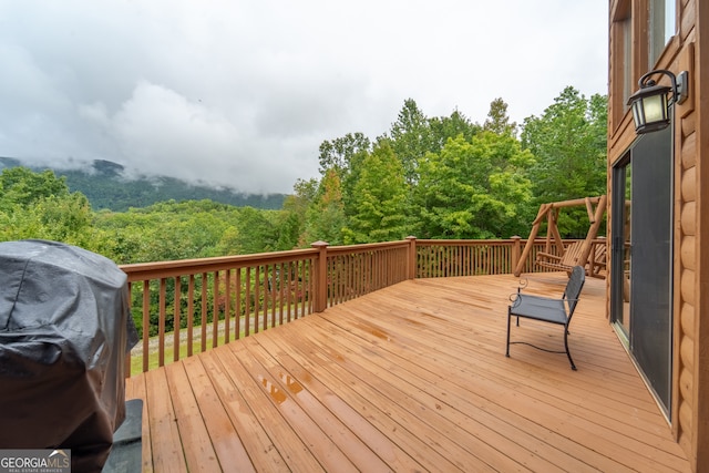 wooden terrace featuring a grill