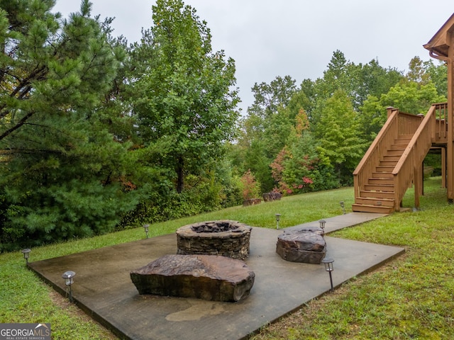 26 Clarice Ln, Sautee Nacoochee, GA 30571 - view of grassy yard featuring an outdoor fire pit, stairs, and a patio