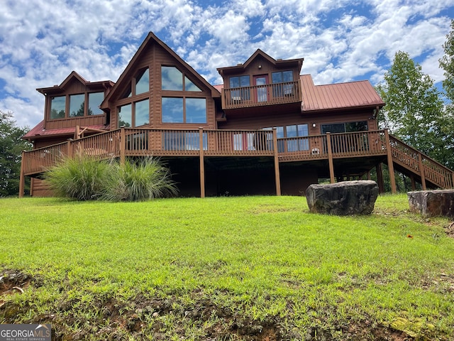 back of house with a wooden deck and a yard