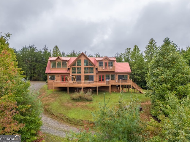 26 Clarice Ln, Sautee Nacoochee, GA 30571 - rear view of house with dirt driveway, a deck, metal roof, stairs, and a yard