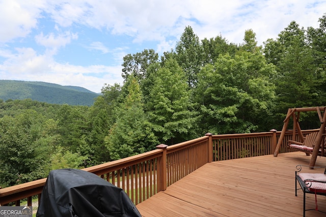 wooden deck featuring a mountain view and grilling area