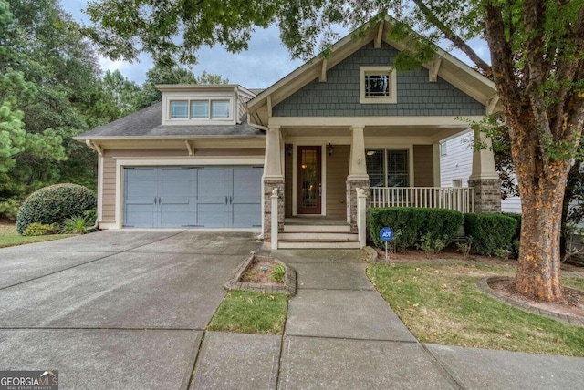 craftsman-style house featuring a porch and a garage