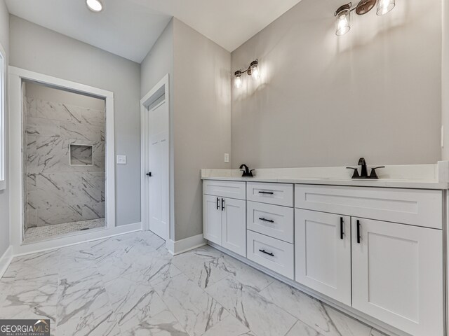 bathroom featuring vanity and tiled shower