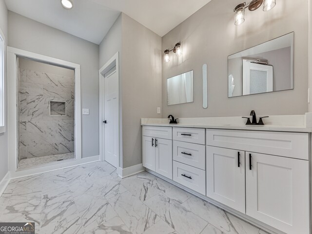 bathroom with vanity and a tile shower