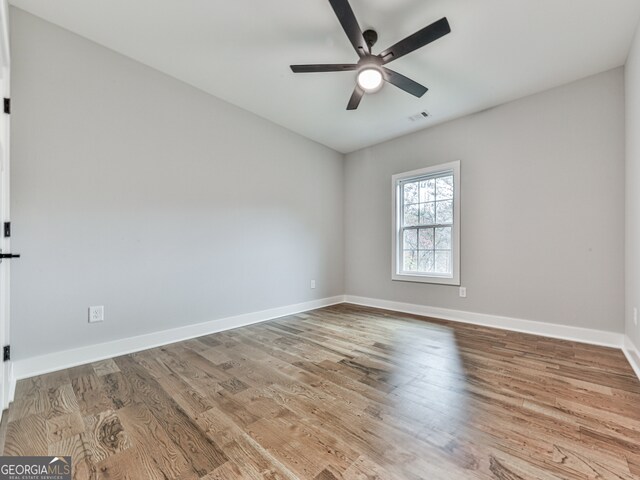 spare room with light hardwood / wood-style floors and ceiling fan