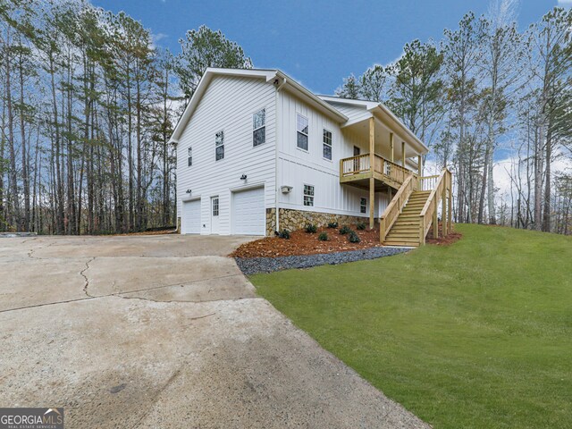 view of side of property with a garage and a yard