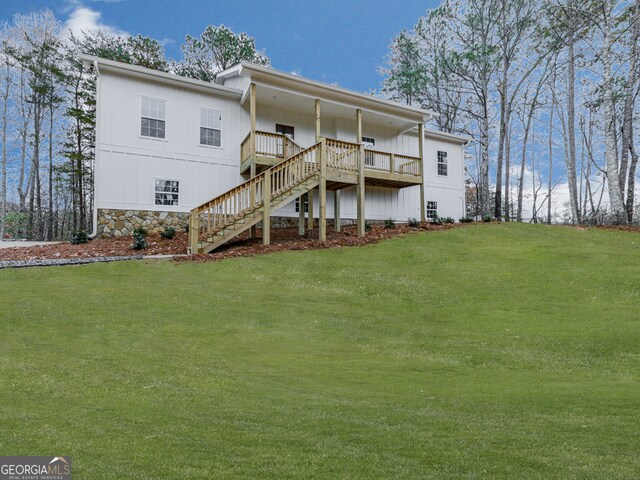 rear view of property with a lawn