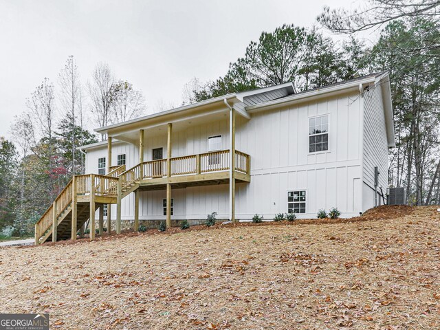 rear view of house featuring central AC unit