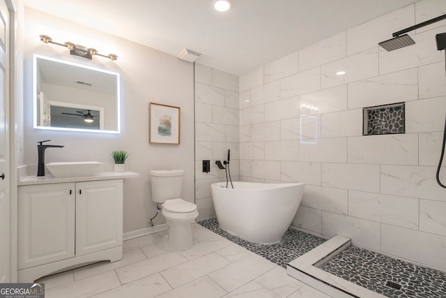 bathroom featuring a soaking tub, marble finish floor, a tile shower, and vanity