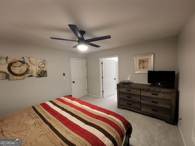 bedroom featuring light carpet, ceiling fan, and baseboards