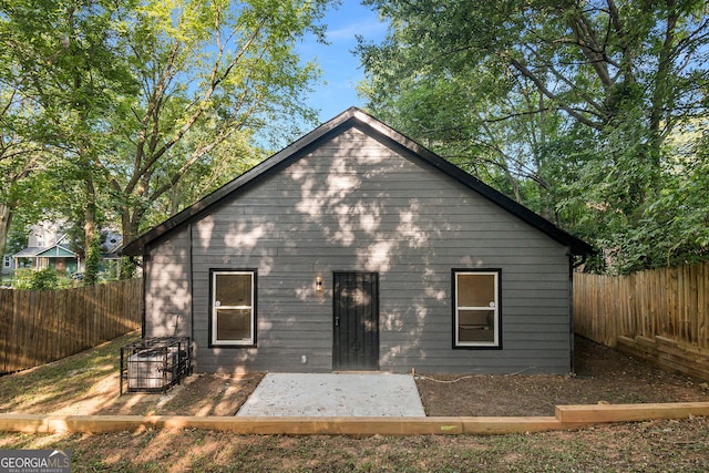 rear view of property featuring a patio area and a fenced backyard