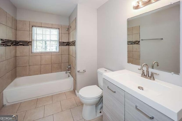 full bathroom featuring tiled shower / bath, vanity, tile patterned flooring, and toilet