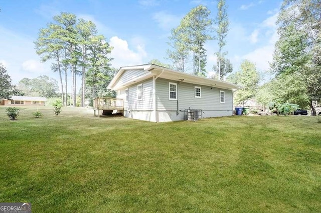 exterior space with a wooden deck and a yard