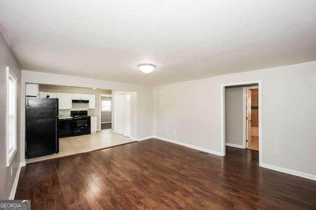 unfurnished living room with hardwood / wood-style flooring