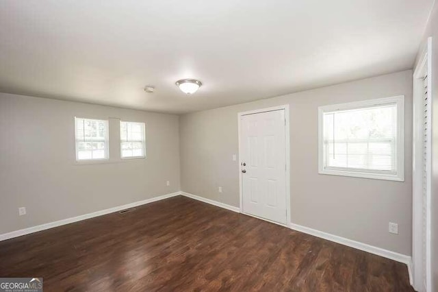 empty room featuring dark hardwood / wood-style floors