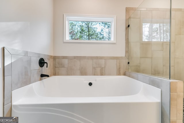 bathroom with a tub to relax in