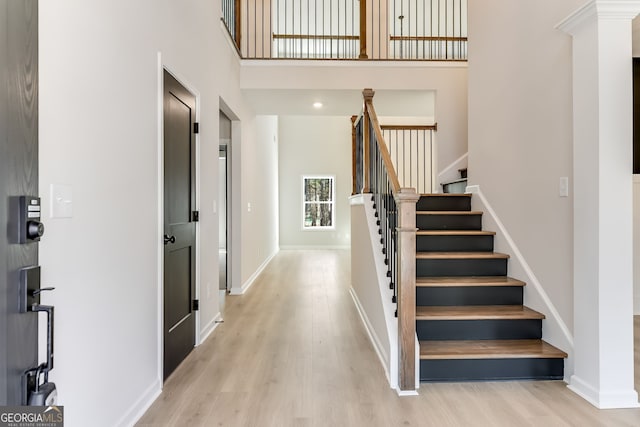 foyer featuring a high ceiling and light hardwood / wood-style flooring