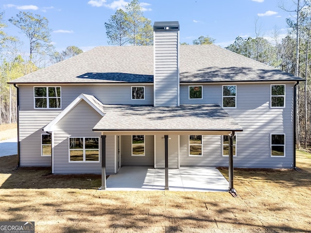 back of house featuring a yard and a patio