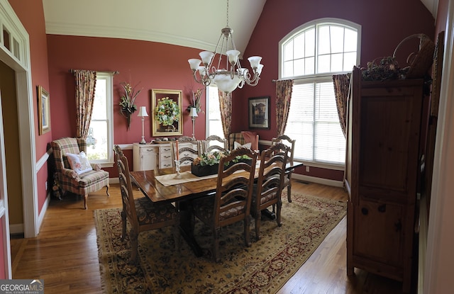 dining space with a notable chandelier, lofted ceiling, and plenty of natural light