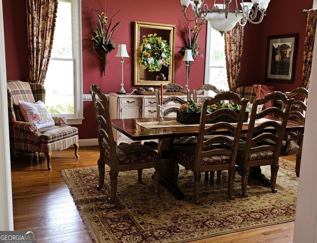 dining room featuring hardwood / wood-style flooring and a notable chandelier