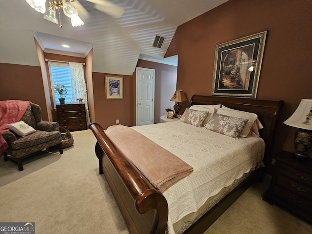 carpeted bedroom with ornamental molding and ceiling fan