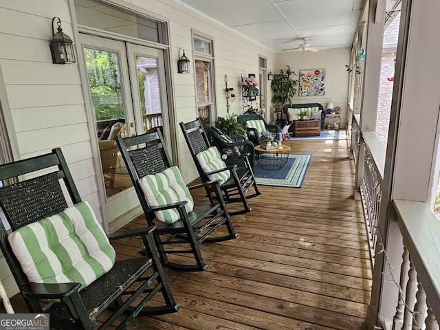 wooden terrace featuring a porch and ceiling fan