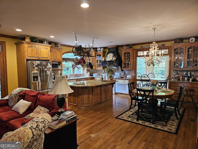 dining space featuring crown molding, dark hardwood / wood-style flooring, and a chandelier