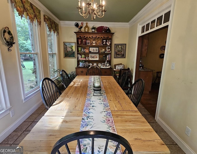 dining room with ornamental molding, tile patterned floors, and an inviting chandelier