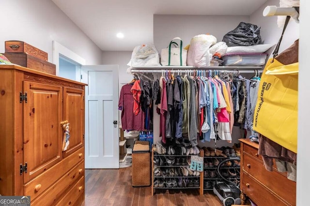 clothes washing area with dark hardwood / wood-style flooring and independent washer and dryer