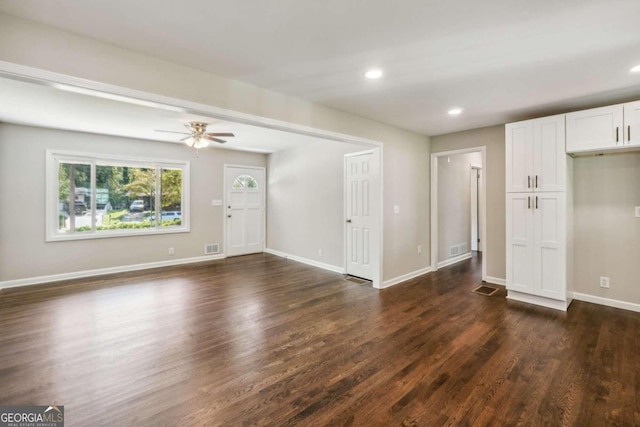 interior space with ceiling fan and dark wood-type flooring