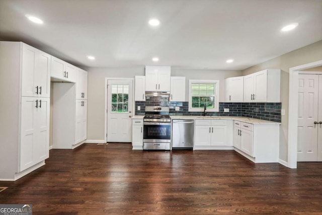 kitchen featuring white cabinetry, dark wood-type flooring, appliances with stainless steel finishes, and a healthy amount of sunlight