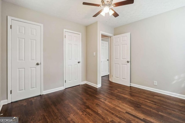 unfurnished bedroom featuring a textured ceiling, dark hardwood / wood-style floors, and ceiling fan