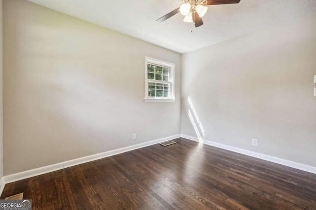 spare room with ceiling fan and dark wood-type flooring