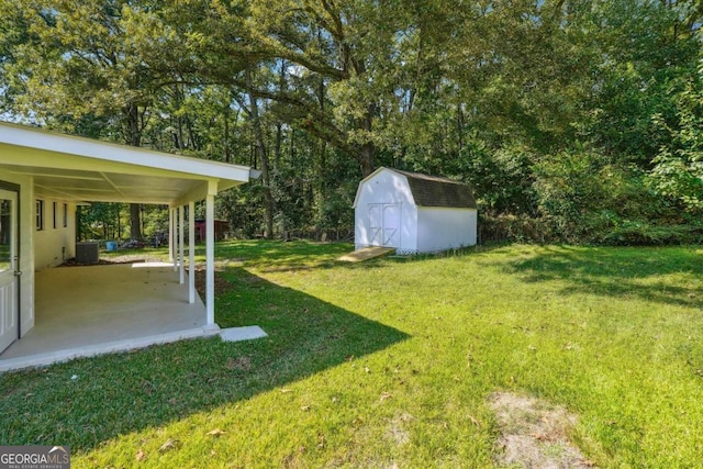 view of yard featuring a storage shed, central AC unit, and a patio area