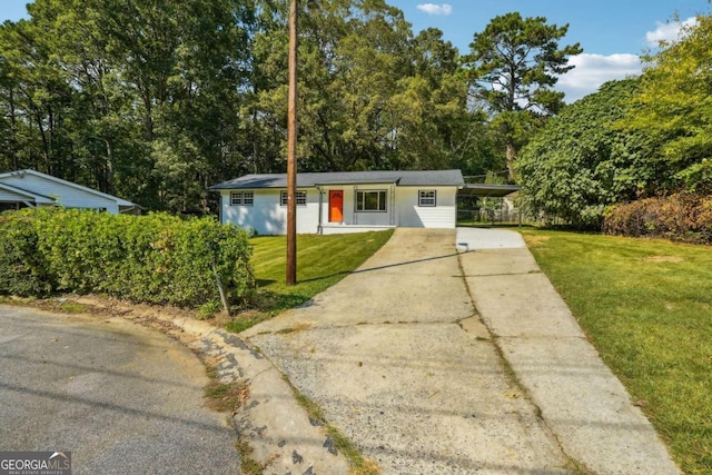 single story home with a front lawn and a carport