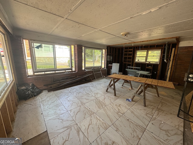 unfurnished sunroom with plenty of natural light