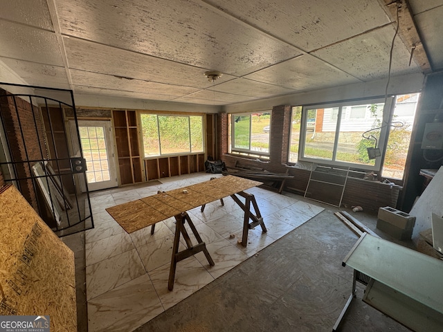 unfurnished sunroom with a wealth of natural light