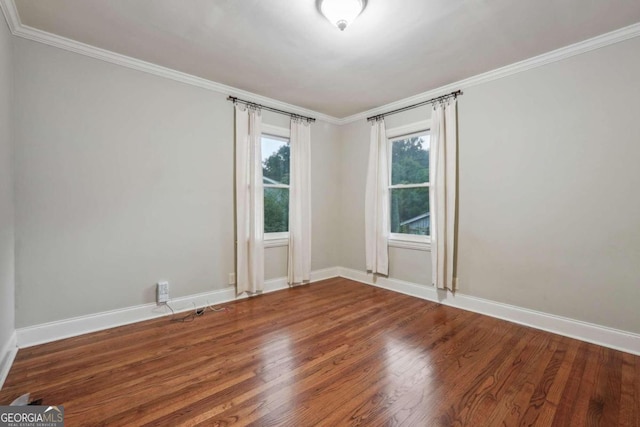 unfurnished room with ornamental molding and hardwood / wood-style floors