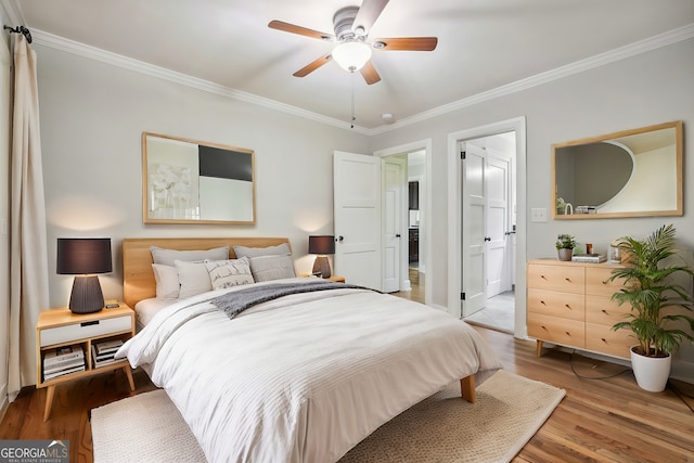 bedroom featuring ornamental molding, hardwood / wood-style floors, and ceiling fan