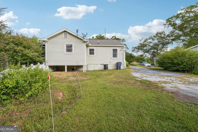 rear view of house featuring a yard