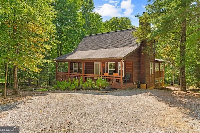 log cabin with a porch