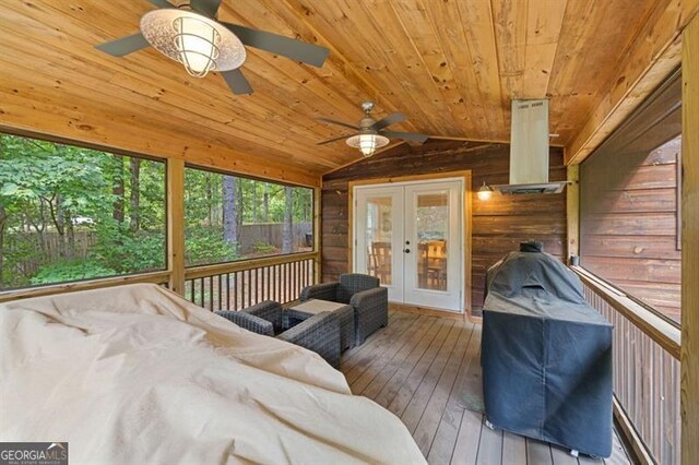 sunroom with wood ceiling, vaulted ceiling, ceiling fan, and french doors