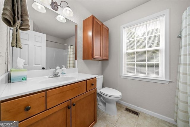 bathroom with vanity, tile patterned flooring, and toilet