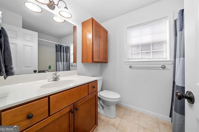 bathroom featuring tile patterned flooring, vanity, and toilet