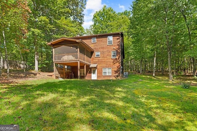 back of house featuring central AC and a yard