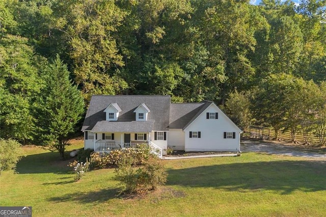 cape cod-style house featuring covered porch and a front yard