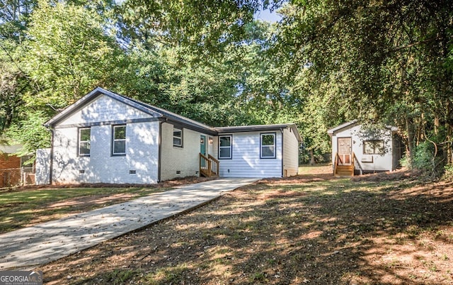 view of front of home featuring a shed