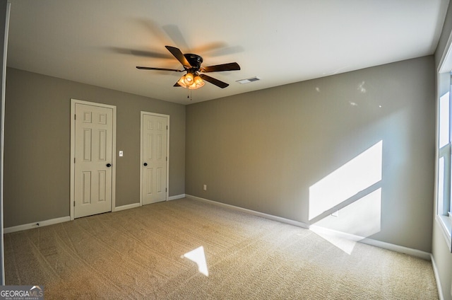 carpeted empty room featuring ceiling fan